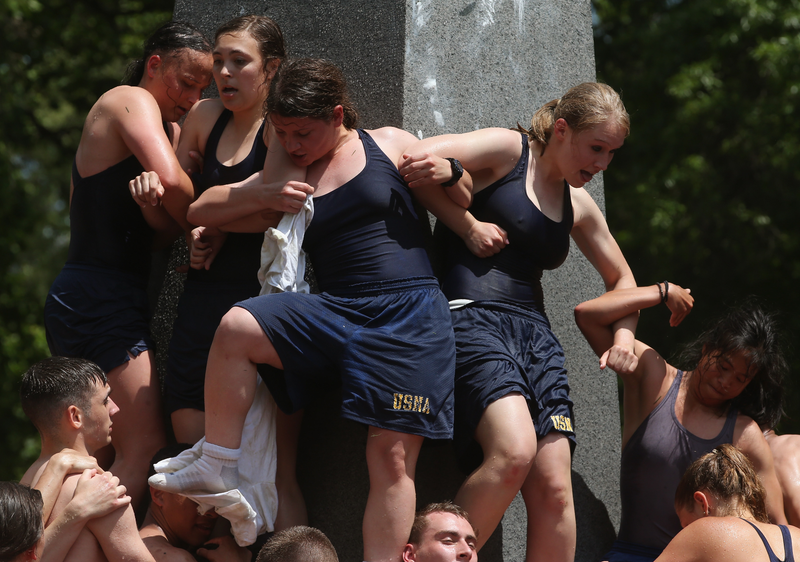 Illustration for article titled Gallery: Greasy Naval Cadets Try To Climb A Lard-Covered Monument